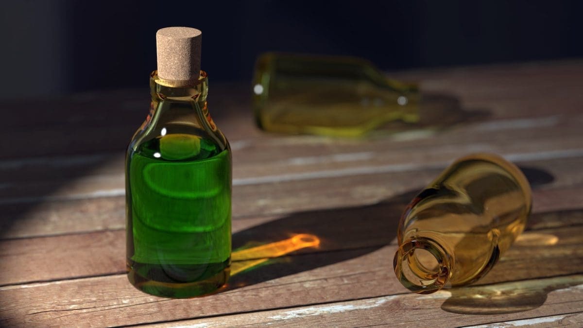 green liquid on clear glass bottle with cork