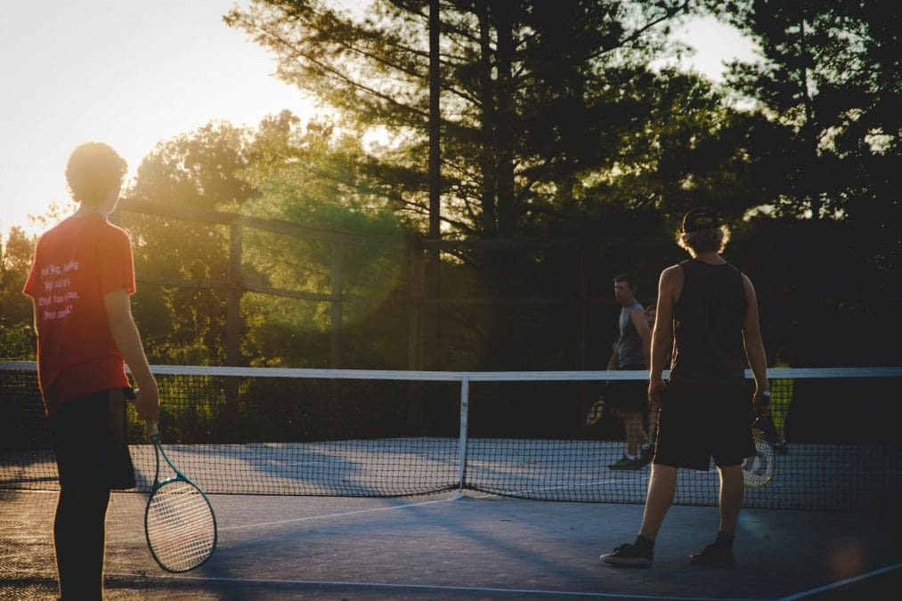 photo of three men playing tennis