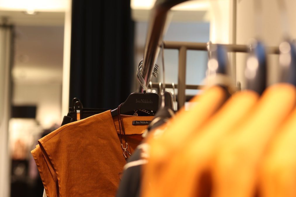 brown top hanging on rack