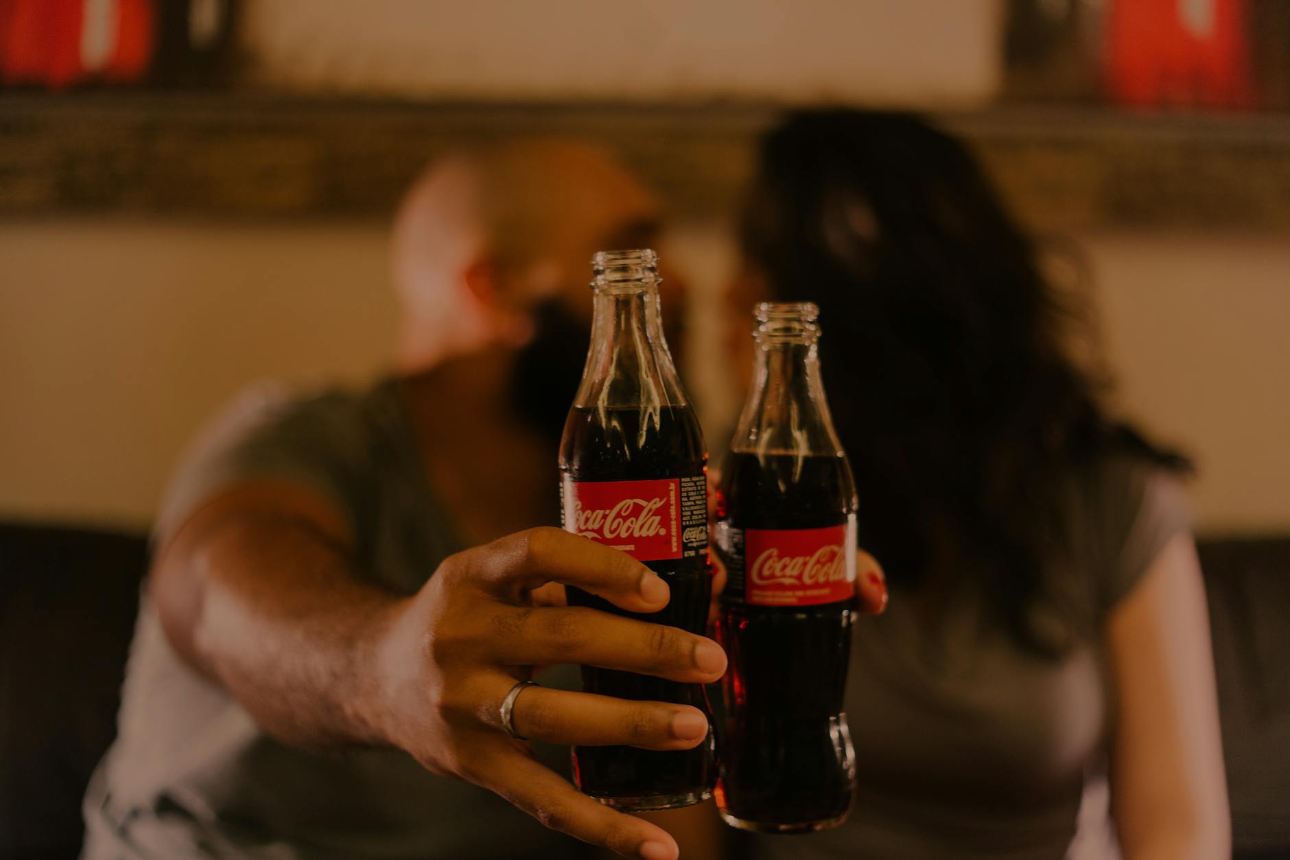 close up photography of people holding coca cola bottles